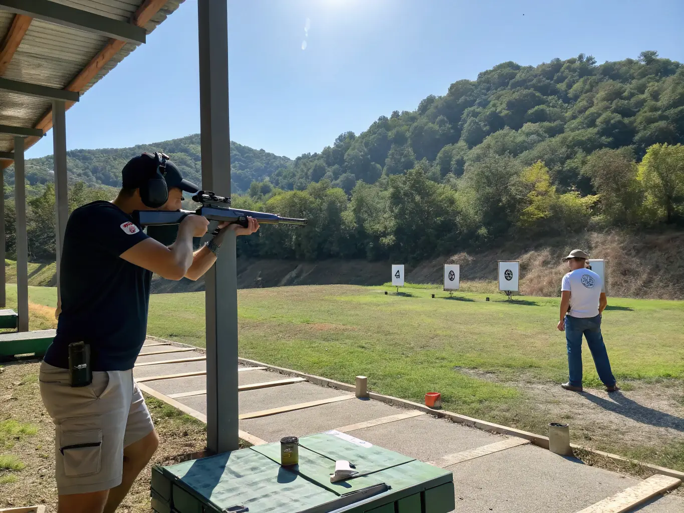 An action shot of competitors aiming at targets during a regional shooting competition, with spectators and officials observing.